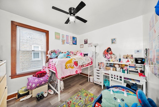 bedroom with ceiling fan and wood finished floors