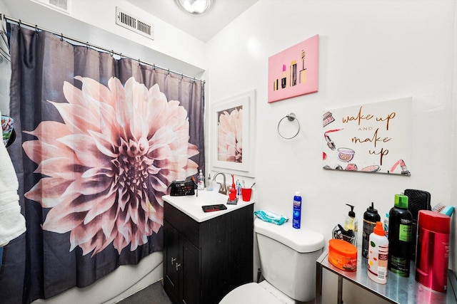 full bathroom featuring toilet, vanity, visible vents, and a shower with curtain