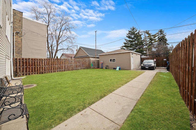 view of yard with a fenced backyard and an outdoor structure