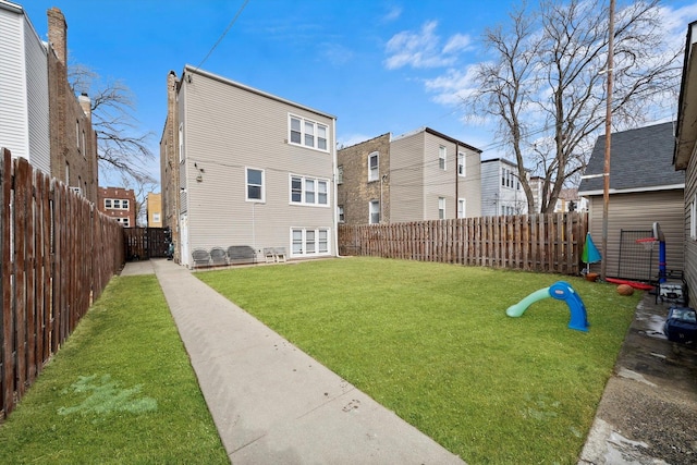 view of yard with a fenced backyard and a playground