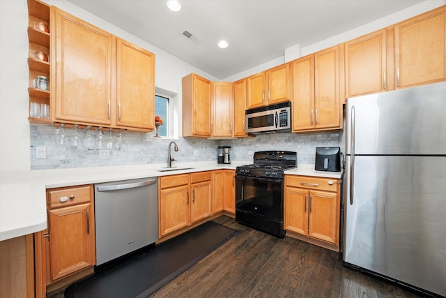 kitchen featuring visible vents, appliances with stainless steel finishes, dark wood-style flooring, light countertops, and a sink