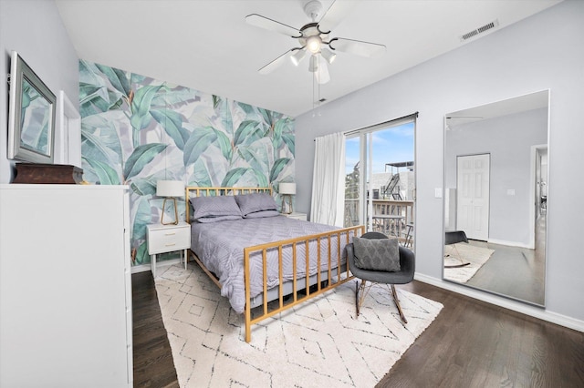 bedroom featuring a ceiling fan, wood finished floors, visible vents, and baseboards