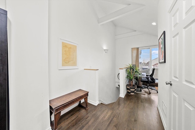 hall with an upstairs landing, dark wood finished floors, lofted ceiling with beams, and baseboards