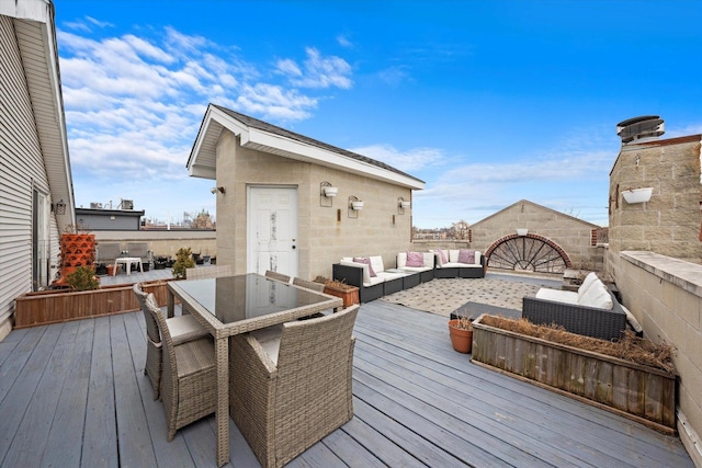 deck featuring outdoor dining area and an outdoor living space