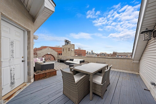 wooden terrace featuring a city view and an outdoor hangout area