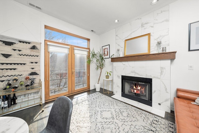 living area featuring recessed lighting, visible vents, and a fireplace