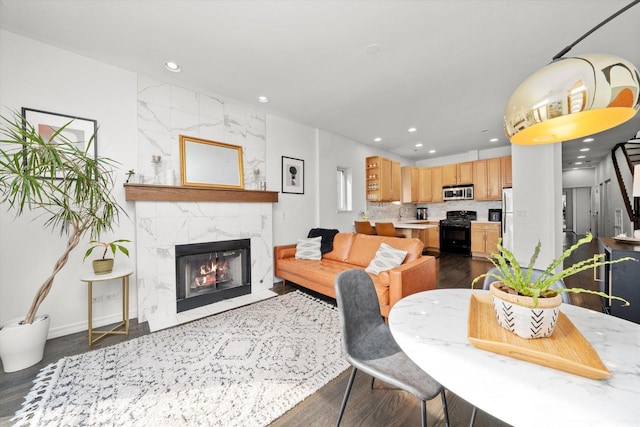 dining room featuring recessed lighting and a high end fireplace