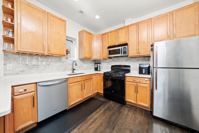 kitchen featuring visible vents, appliances with stainless steel finishes, dark wood-style flooring, light countertops, and a sink