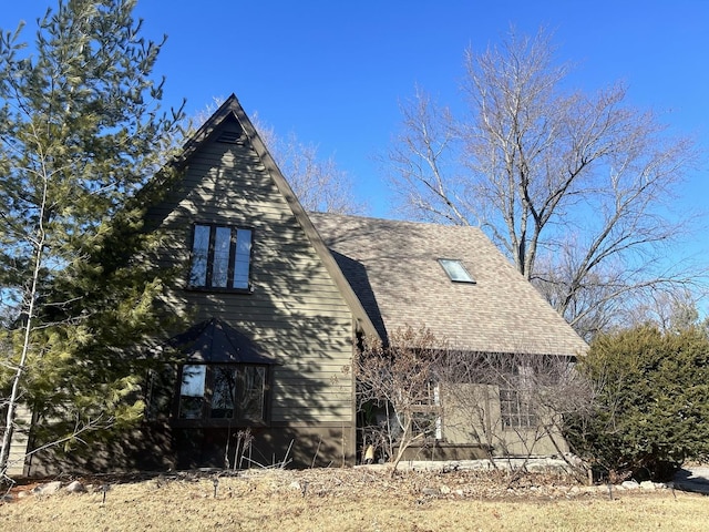 view of property exterior featuring roof with shingles