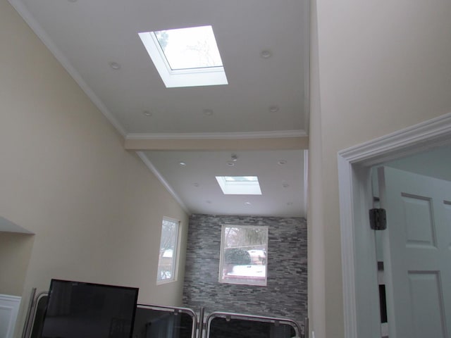 interior space with ornamental molding and vaulted ceiling