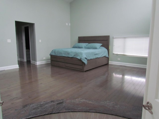 bedroom featuring wood finished floors and baseboards