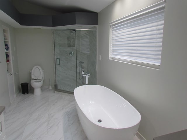 full bath with toilet, marble finish floor, a freestanding bath, and a stall shower