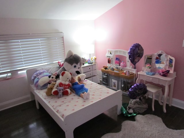 bedroom with wood finished floors and baseboards