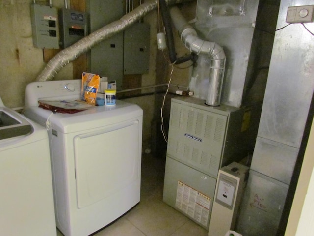 clothes washing area featuring laundry area, electric panel, washer and dryer, and light tile patterned flooring