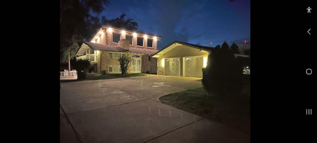 view of front of house with an outbuilding, driveway, and a garage