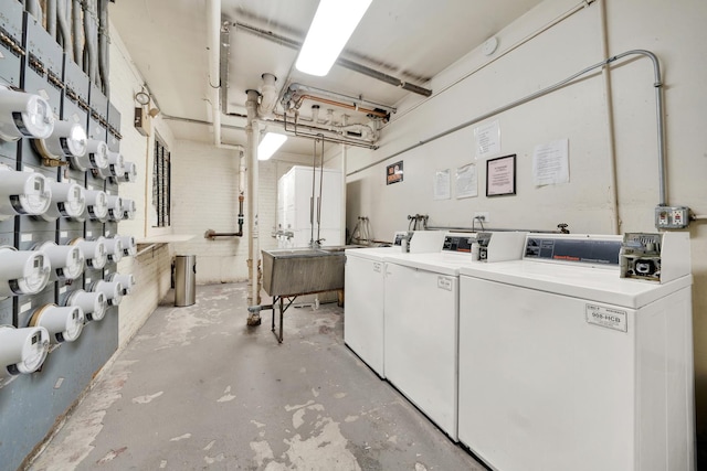 basement featuring washer and clothes dryer and a sink