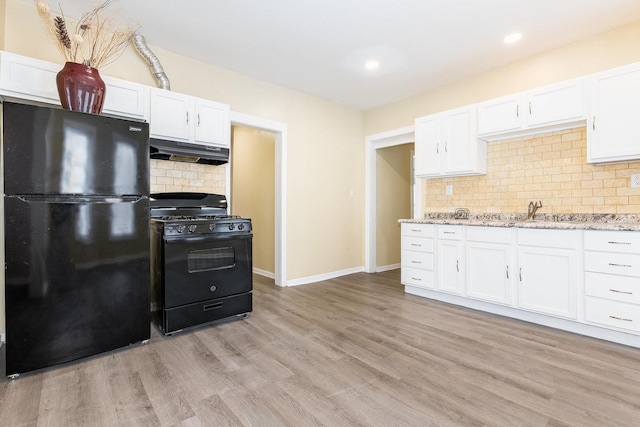 kitchen featuring black appliances, light wood finished floors, white cabinetry, and under cabinet range hood