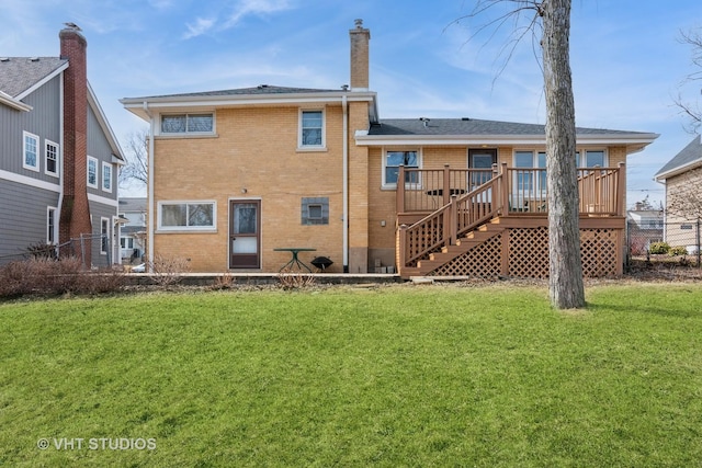 back of property featuring brick siding, a wooden deck, stairs, a chimney, and a yard