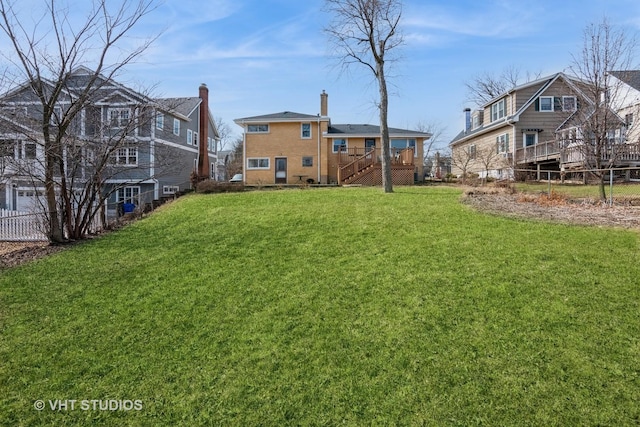 view of yard featuring stairway, a deck, and fence