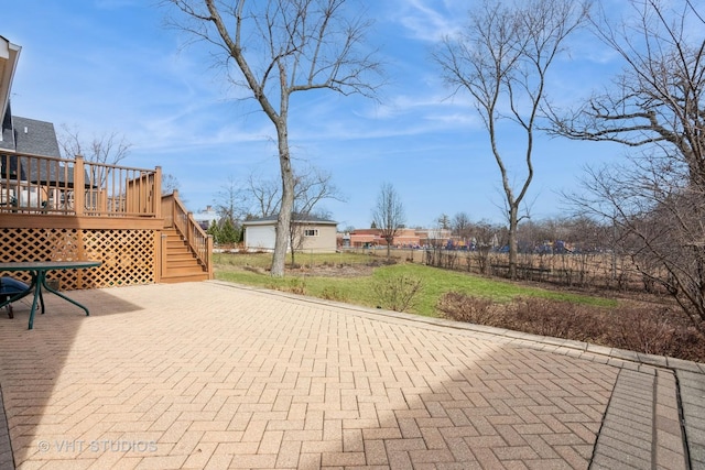 view of patio / terrace featuring a deck, stairs, and fence