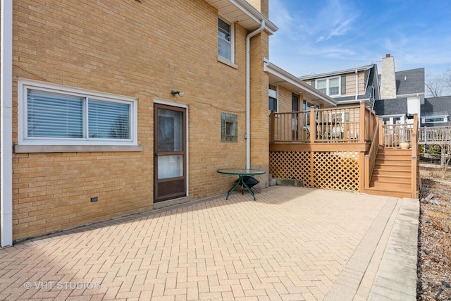 view of patio / terrace featuring a wooden deck and stairs