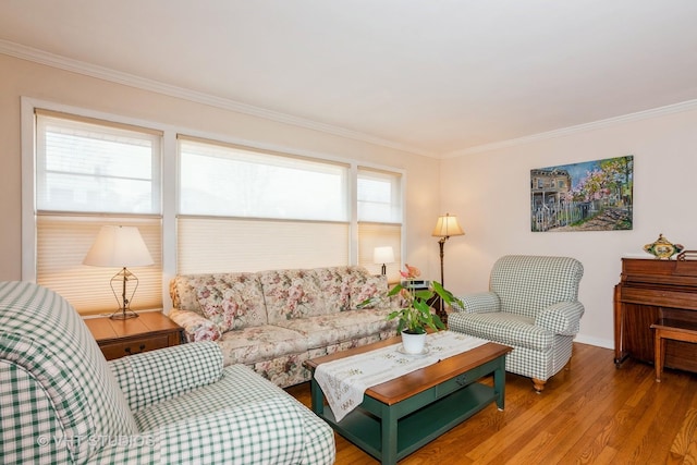 living area with wood finished floors and ornamental molding