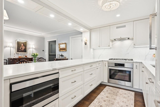 kitchen with white gas cooktop, stainless steel oven, white cabinets, and dark wood-type flooring