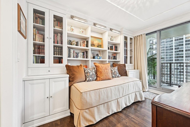 bedroom featuring access to exterior, multiple windows, and dark wood finished floors