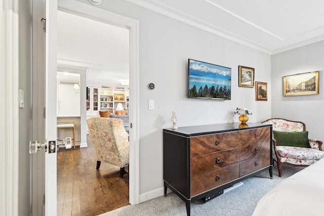 bedroom featuring ornamental molding, wood finished floors, and baseboards