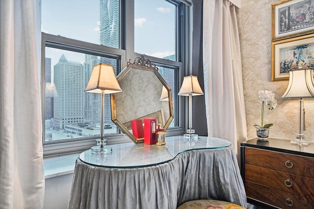 living area featuring wallpapered walls and a city view