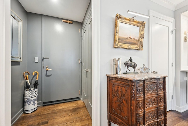 doorway to outside featuring dark wood-style floors and baseboards