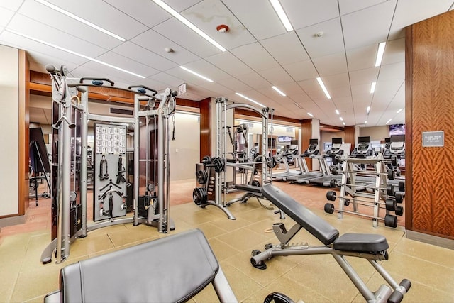 gym with a paneled ceiling