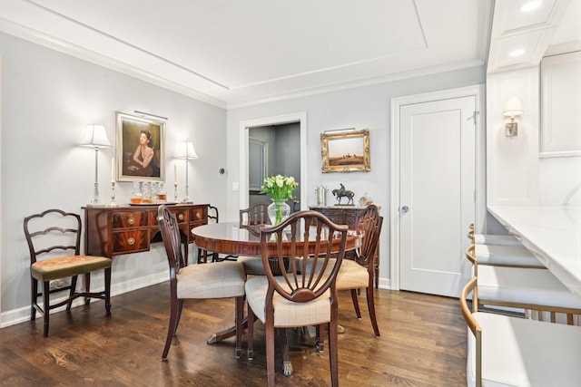 dining room featuring baseboards, dark wood-type flooring, and crown molding