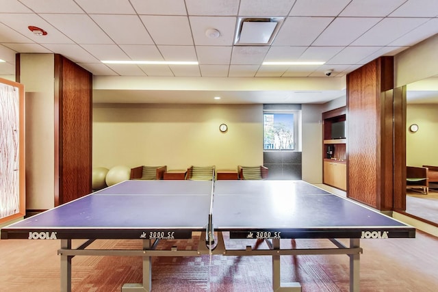 recreation room featuring a drop ceiling