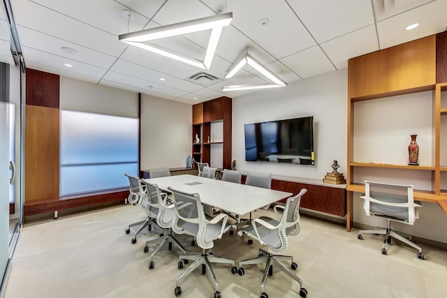 office area with visible vents, a drop ceiling, and recessed lighting