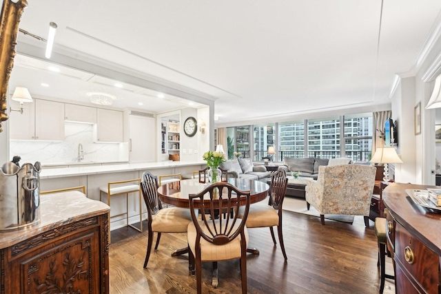 dining area featuring dark wood-style floors and crown molding