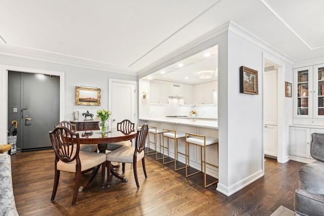 dining room with ornamental molding and dark wood-style flooring