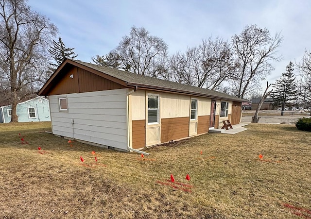 view of side of home with a yard