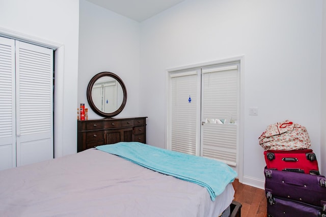 bedroom with baseboards and wood finished floors