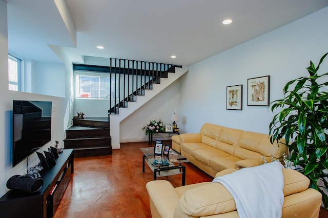 living room with baseboards, stairs, finished concrete floors, and recessed lighting