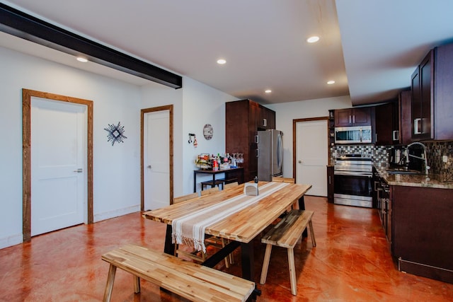 interior space with dark brown cabinetry, recessed lighting, a sink, appliances with stainless steel finishes, and decorative backsplash