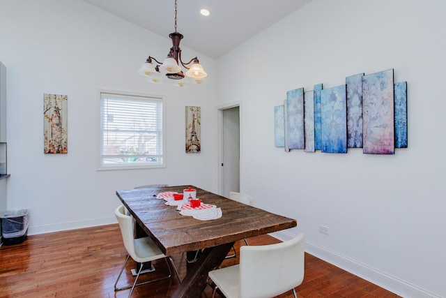 dining area featuring high vaulted ceiling, recessed lighting, wood finished floors, baseboards, and an inviting chandelier