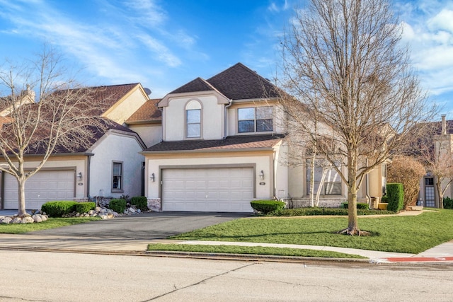 view of front of house featuring a front yard, roof with shingles, driveway, stucco siding, and a garage