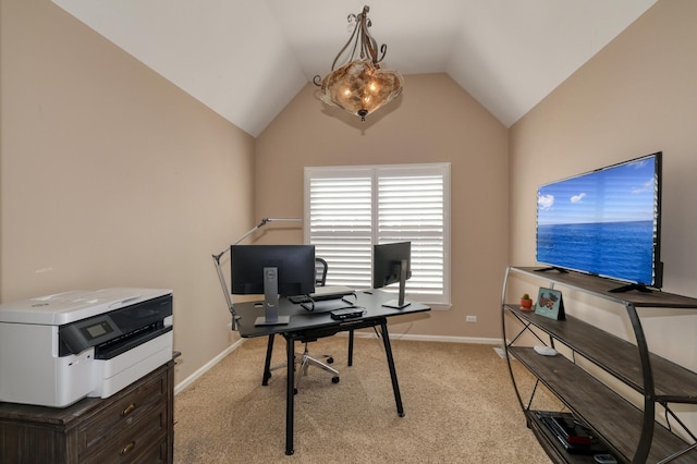 office space featuring vaulted ceiling, baseboards, and light carpet