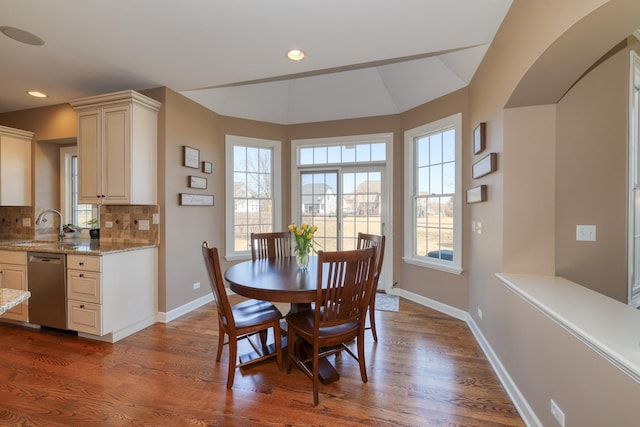 dining room with plenty of natural light, baseboards, and dark wood-style flooring