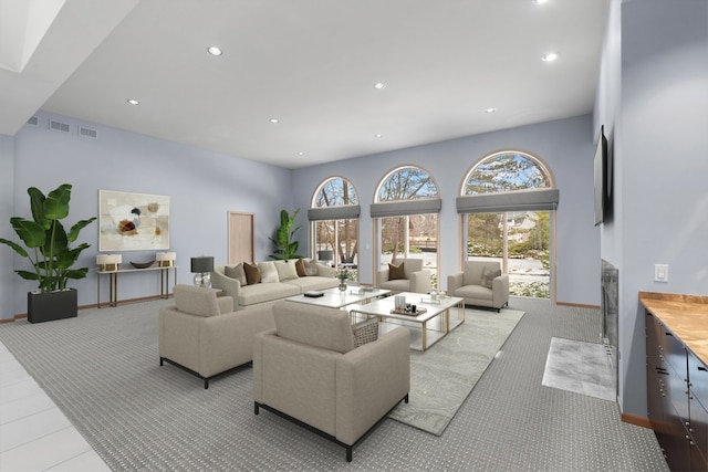 living room with baseboards, visible vents, and recessed lighting