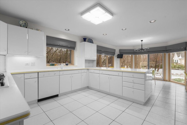 kitchen featuring a peninsula, light tile patterned flooring, light countertops, white cabinetry, and recessed lighting