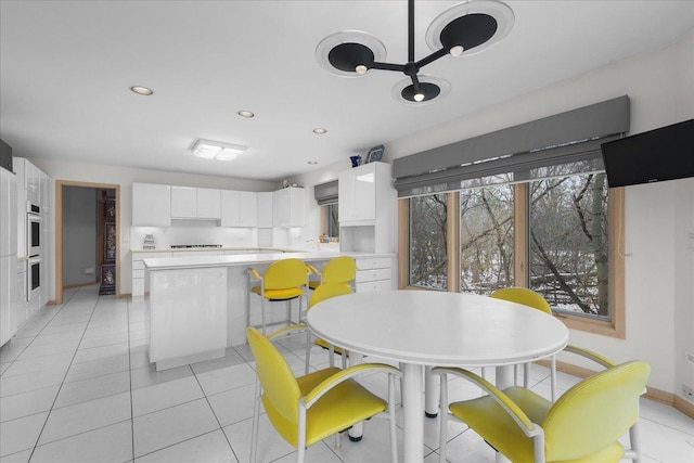 dining room with recessed lighting, light tile patterned flooring, and baseboards