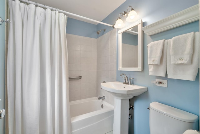 full bathroom with toilet, shower / bathtub combination with curtain, and a sink