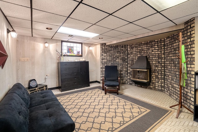 living room with a drop ceiling and visible vents